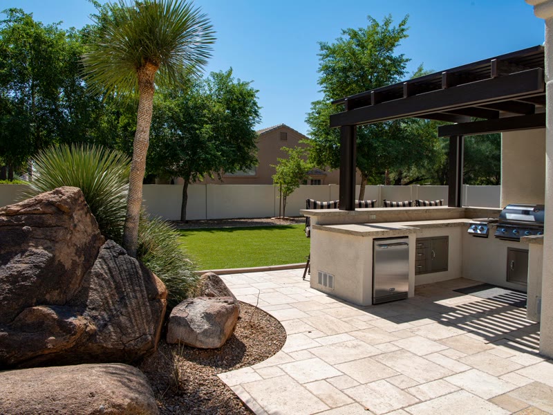 A finished paver patio with an outdoor kitchen