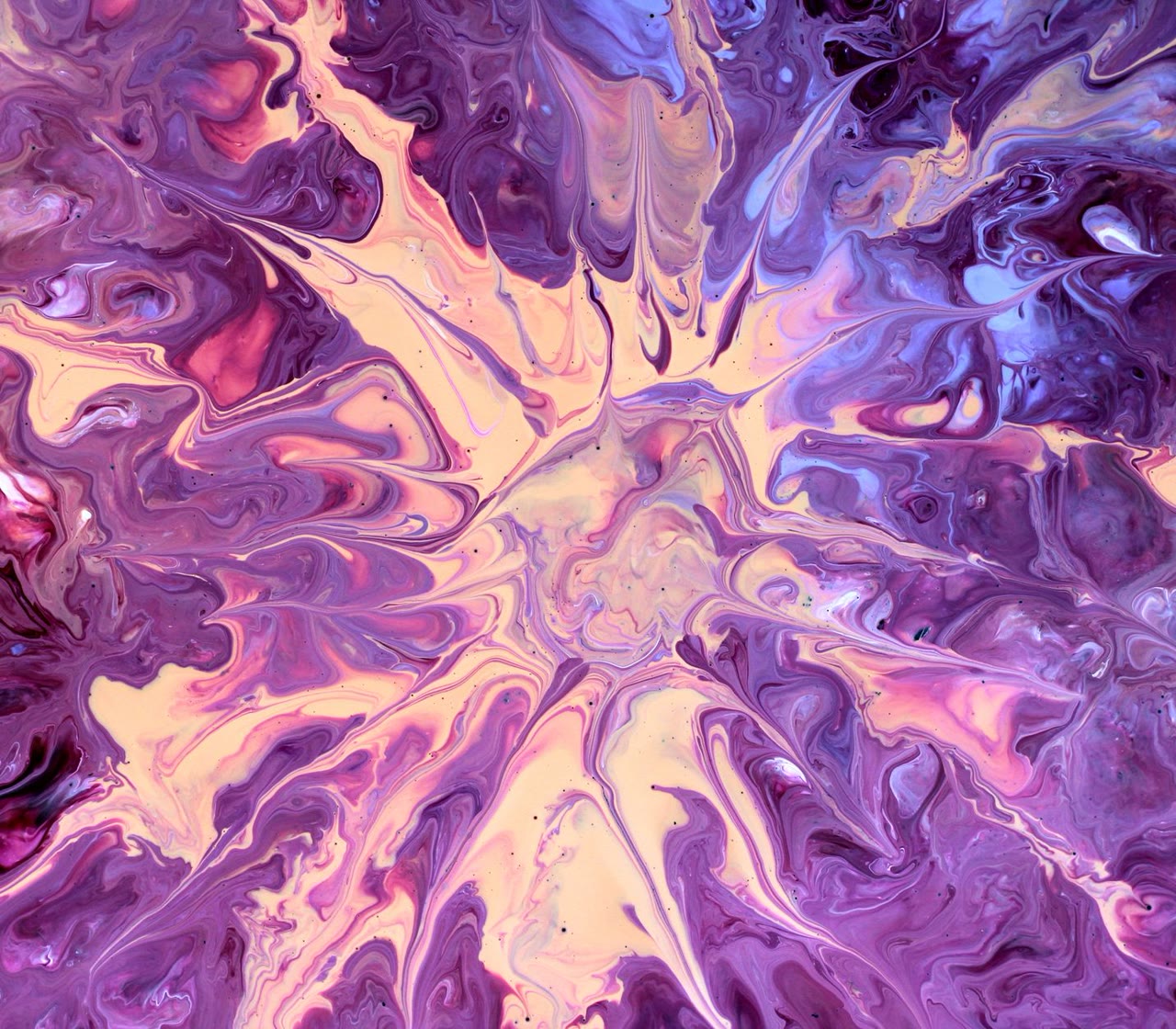 Purple and pink fluid paint in swirls